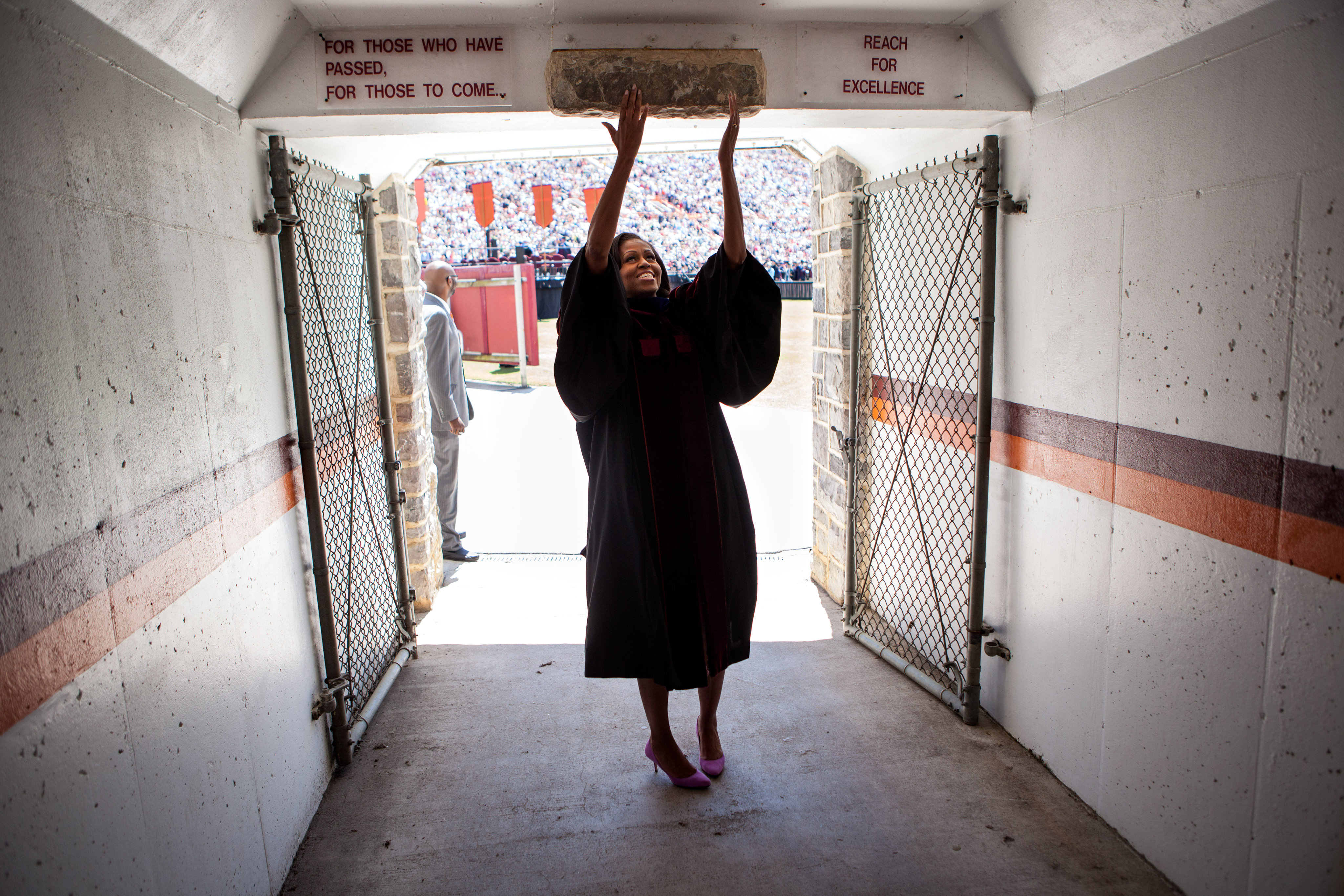 First Lady Michelle Obama touches the Hokie Stone before walking onto the field at Lane Stadium to give the Virginia Tech commencement address in Blacksburg, Va., May 11, 2012. (Official White House Photo by Lawrence Jackson) This official White House photograph is being made available only for publication by news organizations and/or for personal use printing by the subject(s) of the photograph. The photograph may not be manipulated in any way and may not be used in commercial or political materials, advertisements, emails, products, promotions that in any way suggests approval or endorsement of the President, the First Family, or the White House.
