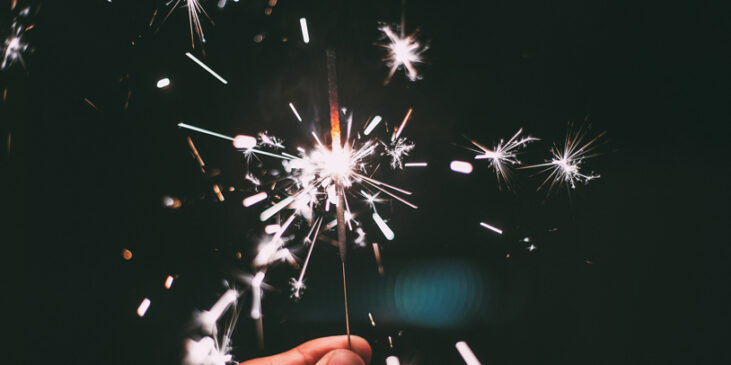 Person holding a sparkler for Independence Day